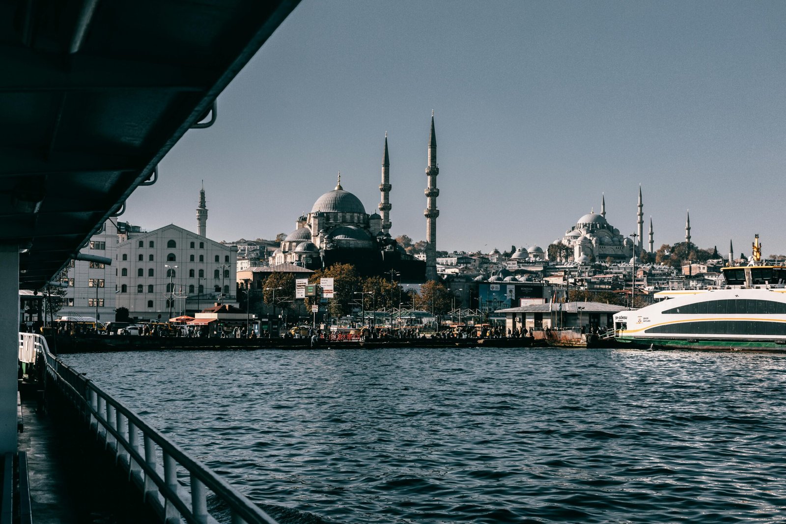 View of Istanbul's waterfront with iconic mosque and ferry, capturing the city's vibrant culture and architecture.